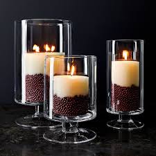 Crafted with a metal frame, this piece strikes a cylindrical silhouette measuring 16'' h x 9.1'' w x 9.1'' d to grab. London Large Clear Hurricane Candle Holder Reviews Crate And Barrel Glass Hurricane Candle Holder Hurricane Candles Hurricane Candle Holders