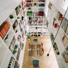 What are bookshelves used for? Two Storey Bookshelf Rises Inside Renovated Madrid House