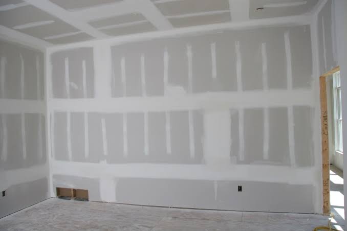 Living room with damaged peeling paint walls before restoration in Langley