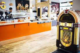 Orange Cafe Counter Juke Box Copper Lighting Cafe Counter Orange Cafe Cafe Design