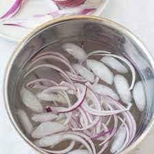 Take your knife and cut right down the middle, from one stem end to the other as shown in the photos above. Take The Bite Out Of Raw Onions With This One Simple Step Kitchn