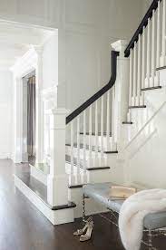 Large Wainscoted Walls Amidst A Wood Panel Staircase Curve Elegantly While Displaying Black Railing And Column C Staircase Decor Foyer Decorating Foyer Design