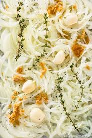 Overhead Up Close Photo Of Sliced Onions Drizzled With Olive Oil And Topped With Thyme Brown Sugar Garlic Caramelized Onions Recipe Caramelized Onions Onion