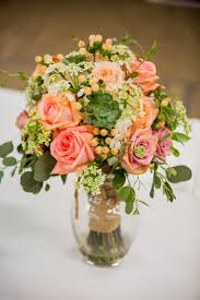 A draped coral strapless wedding dress, a gold and coral wedding bouquet in a creamy wrap for a chic and cool look. Pantone Coral Wedding Trend Color Fancy Florals By Nancy