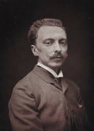 Portrait of Ernest Gross, scenic designer, sitting in his studio at his  drafting table, 1908-9