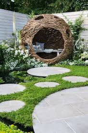 Woven Willow Bird Hide Willow Sculpture And Concrete Circular Slabs As A Path Over A Pond Garden Furniture Design Garden Design Diy Exterior