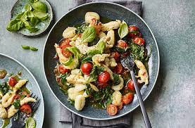 Everyone pausing in the middle of an otherwise bustling day to gather around a spread of delicious food to connect and share. Easy Recipes Family Meal Ideas Tesco Real Food