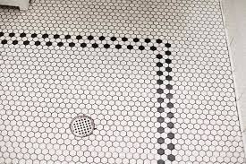 Black And White Hexagon Tile Bathroom Steal This Look A Dash Of Purple For A Black And White Powder Room Gardenista Hexagon Tile Bathroom Floor Bathroom Floor Tiles Bathroom Tile Designs