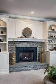 The result is a gray fireplace surround that is also warm and welcoming. Fireplace With Stacked Stone And White Mantel And Built Ins Google Search Fireplace Built Ins Home Fireplace Stacked Stone Fireplaces