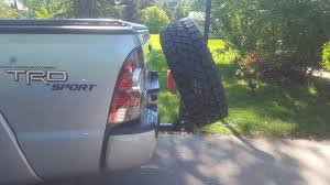 I've seen a guy driving around with one but i can never catch him. Hitch Mounted Tire Carrier Tacoma World