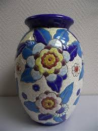 Beau Vase De La Celebre Boch Usine Du Monde Ce Vase Est Un Dessin De Charles Catteau Le Vase A Un Decor Floral Emaille Vase De Poterie Art Deco Vases Bleus