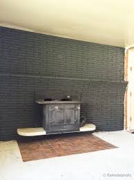 Red brick does not have to be a permanent, unchangeable feature in your home. Remodelaholic Painted Black Brick Fireplace