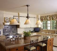Traditional Kitchen Island Lit With A Custom Large Scale Linear Chandelier Kitchen Chandelier Traditional Kitchen Island Lighting Lighting Design Inspiration