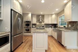 If the place is suitable in the open plan kitchen, you can divide the perception of space by using the outer corners. Kitchen In Suburban Home With Light Colored Cabinetry Stock Photo Picture And Royalty Free Image Image 6738393
