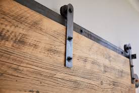 The sliding barn door is made of engineered alder which is a sustainable wood; Rustic Reclaimed And Hand Aged Sliding Barn Doors