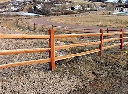 The split rail, or post and rail, fence is essentially a rustic version of a post and board fence style and is similarly a good choice for a decorative accent, for delineating areas, or for marking boundaries without creating a solid visual barrier. Split Rail Fence Kalinich Fence Company