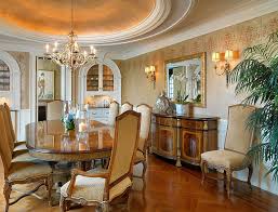 This chic dining room has brown floral patterned cushions on the dining chairs matching the floral patterned area rug that contrasts the hardwood flooring. Glitter And Majestic Panache Dining Rooms Wrapped In A Golden Glint