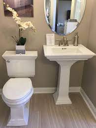 In a smaller bathroom, a pedestal sink would fill the space nicely without making it look or feel too tight. Memoirs Powder Room Pedestal Sink And Commode Pedestal Sink Bathroom Powder Room Sink Powder Room Ideas Half Baths