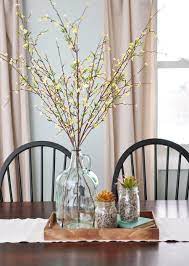 This vibrant table runner brings the best of both worlds—delicate flowers and sweet fruit. A Simple Neutral And Natural Centerpiece Dining Room Table Centerpieces Dining Table Centerpiece Dinning Table Centerpiece