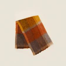 These brightly coloured plaids, structured geometrically, are shaped by woven vertical stripes and colours that are dyed after weaving on each edge of the plaid, thus creating new chromatic variations. Plaid Mohair Throw Warm Hawkins New York