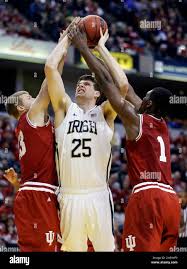 Notre Dame forward Tom Knight, center, is fouled as he shoots by Indiana  forward Austin Etherington, left, and forward Noah Vonleh in the first half  of an NCAA college basketball game in