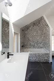 Maybe you would like to learn more about one of these? Vertical View Of Modern House With Contemporary Interior Design In Bathroom White Tub Sink On Countertop Mirror Black White Tiles On Floor And Wall Stock Photo Picture And Royalty Free Image Image