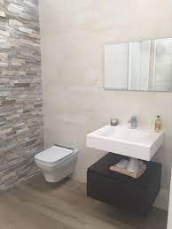 split face slate stone tile feature wall and bathroom tiles by porcelanosa neutral colours create a c neutral bathroom tile tile bathroom bathroom wall tile