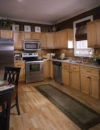 This makes for a dramatic feature wall in the entry of the apartment. Kitchen Chocolate Brown We Re Repainting Our Rust Colored Kitchen To Brown And The Cabinets Are Sim Brown Kitchen Cabinets Brown Kitchens Light Oak Cabinets