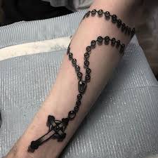This tattoo involves a subtle black and gray inked rosary chain made of tiny dots, shaped like small diamonds, with a big black and white inked cross hanging from the rosary. 51 Rosary Tattoo Ideas With Meaning August 2021