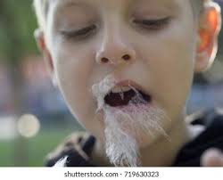 Kid Holding Cotton Candy Photos, Images and Pictures