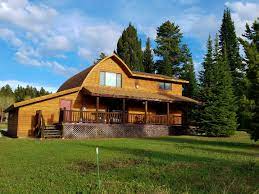 From the outside, you'll notice beautiful cedar shakes and a grey metal roof. Red Cedar Cabin Mountain Home Montana Vacation Rentals