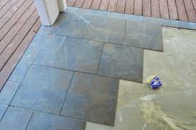Leveling And Dry Fitting Tile In An Outdoor Area Patio Tiles Concrete Patio Makeover Outdoor Tile Patio
