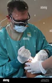 A US Air Force Dentist, assigned to 22nd Aerospace Medical Squadron,  extracts a tooth from a Guatemalan child during a Medical Readiness  Training Exercise during Beyond the Horizon 2014, Zacapa, Guatemala, Apr.