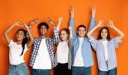 Student standing against a wall