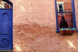 By adding a small retainging wall to the side of this home, and extending it to a sort of, front patio, a quaint, lush, front space is created. Beautiful Old Brick Wall With Blue Door And Window Stock Image Image Of Holiday Colorful 67832363