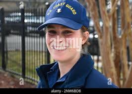 A maritime enforcement specialist from an Maritime Safety and Security Team  (MSST) waves to tourists aboard Coast Guard Cutter Richard Snyder