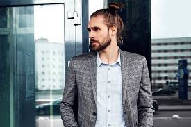 How To Get Style And Sport The On Trend Man Bun Hairstyle Head of a hipster man with big mustache and long beard. man bun hairstyle