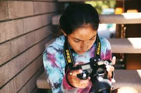 Smiling mixed race teenager recording vlog, streaming for social media or video calling in online chat at home. 2021 Best Summer Camps For Los Angeles Teens