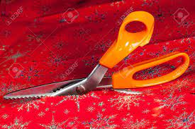 Christmas Paper Being Cut By Special Scissors To Create Pattern In The Cut Edge Stock Photo Picture And Royalty Free Image Image 11526701