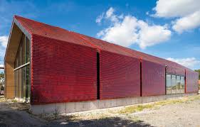 The Shimmering Ruby Red Glazed Tiles Enhance The Building S Surface Creating A Building Envelope Of Visual Delight Architecture Facade Architecture Brickwork