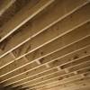 Flat wooden beams are exposed on basement ceiling to give it an unusual look. 1