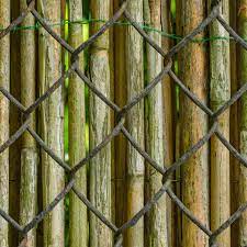 A wooden trellis fence provides more privacy and beauty than that of a chain link fence. How To Cover A Chain Link Fence For Privacy