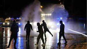 From middle english riot (debauched living, dissipation), from old french riote (debate), from rioter (to quarrel), perhaps related to riboter or from latin rugio (i roar). Ni Riots Police Say 19 Officers Injured In Latest Night Of Violence Bbc News