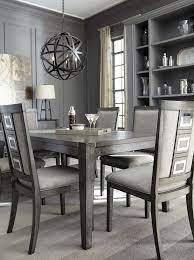 This dining room features wooden dining table paired with modern chairs along with white bookshelves. Chadoni Gray Rectangular Extendable Dining Table Grey Dining Room Table Grey Dining Tables Grey Dining Room