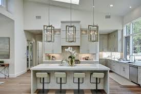 Gorgeous kitchen features a high ceiling with a dark stained truss ceiling over white cabinets paired with white marble countertops and backsplash. Rooms Viewer Hgtv Vaulted Ceiling Kitchen Transitional Decor Kitchen Ceiling Design