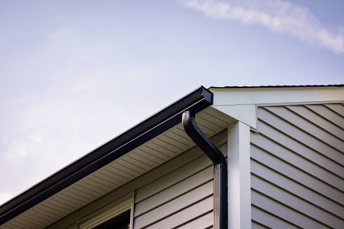 Gutters and downspouts running along the roofline of a Belleville, Michigan home