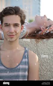 young man lying in shallow water Stock Photo