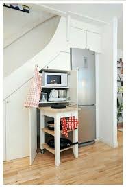 Hidden pantry under the stair by kathryn shaffer architect this photo shows a kitchen pantry that was built to utilize space under a stair with shallow cabinets at the top, deep pull out shelves on the bottom and folding shelves in the middle. Fridge Recessed Under Stairs And Cabinet Storage Would Make A Perfect Pantry Space Saving Kitchen Kitchen Under Stairs Free Kitchen Design