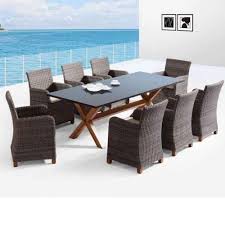 Patio furniture and outdoor furniture large round outdoor dining table on heavy wooden blocks base, with thick concrete gray stone slab top. Blue Stone 8 9pc Granite Stone Top Outdoor Dining Set With Rattan Wicker Chairs United House Furniture