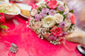 The flowers are simply set inside the bridal couple pots making them easy to transport to the reception venue after the ceremony. Colorfull Wedding Flowers Bride And Groom With Engagement Gold Rings Put On The Table And Next